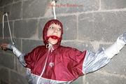 Nicole tied and gagged by Sophie in an red/silver PVC rainsuit in the cellar