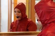 Jill ties, gagges and hoodes herself in front of a mirror and in an strairway wearing a sexy shiny nylon rain pants in black and a red rain jacket (Pics)