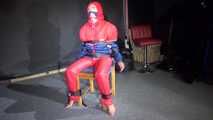 Sandra wearing a sexy OLDSCHOOL shiny nylon downsuit sitting on a chair being tied, gagged and hooded with tension belts and a clothgag (Video)