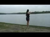 Enni wearing sexy shiny nylon shorts and top while throwing stones in a lake (Video)