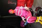 Watching sexy Pia being tied and gagged with ropes and a clothgag on a hairdressers chair wearing a very sexy pink rainwear combination with hood (Pics)