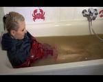 Mara wearing a sexy shiny nylon shorts and a rain jacket enjoying mud in her bath tub (Video)