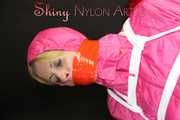 Watching sexy Pia being tied and gagged with ropes and a clothgag on a hairdressers chair wearing a very sexy pink rainwear combination with hood (Pics)