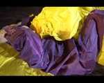 Lucy wearing a purple rain suit preparing her bed cloths for enjoying herself and the rain suit in bed lolling around (Video)