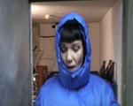 Jill in a cold room wearing shiny nylon rain pants and a down jacket (Video)