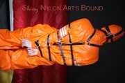 Sexy Pia being tied and gagged with belts a eye patch and a ballgag on a chair wearing a supersexy oldschool orange rainsuit (Pics)