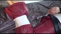 Mara tied and gagged on bed with tape, cuffs and a cloth gag wearing a black/red crazy sensation downwear (Video)