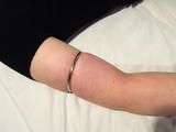 Tight closed metal rings for Leas beautiful white upper arms