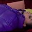Jill tied and gagged on a red sofa wearing a black shiny nylon rain pants and a shiny down jacket (Video) 