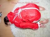 Jill tied, gagged and hooded on the floor wearing a super hot white shiny nylon shorts and a red rain jacket (Pics)