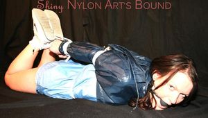 Beautiful brown haired archive girl tied and gagged on the floor in a studio wearing an old fashioned adidas shorts and a rain jacket (Pics)