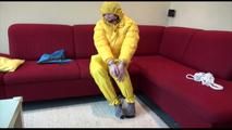 Jill ties, gagges and hoodes herself wearing a shiny yellow down jacket and a yellow rain pants(Video)