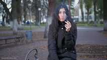 Raven-haired smoker takes a drag on a cork cigarette of her favorite brand