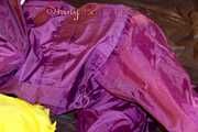 Lucy wearing a supersexy purple rain suit with hood while preparing her bed (Pics)