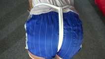 Sexy Pia being tied and gagged with ropes and a cloth gag on a stool wearing a sexy blue shiny nylon shorts and a tshirt (Video)