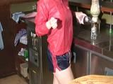 Jill Diamond woring on a bar wearing a sexy shiny nylon shorts and a rain jacket (Video)