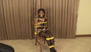 Video - Chair-Tied Asian in sexy black stockings and lingerie.