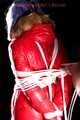 Mara wearing a sexy black shiny nylon down pants and a brandnew red special down jacket tied and gagged overhead with ropes (Pics)