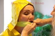 Jill tied, gagged and hooded on a stairway wearing a sexy shiny yellow rainwear combination (Pics)