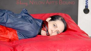 ***HOT DESTINY*** tied and gagged with ropes and a cloth gag on bed wearing a sexy shiny nylon shorts and an oldschool rain jacket (Pics)