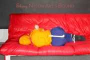 Lucy tied and gagged on a sofa wearing an orange shiny nylon rain jacket and a blue rain pants (Pics)