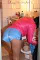 Watching a sexy archive girl wearing a hot lightblue shiny nylon shorts and a pink shiny nylon rainjacket doing her household (Pics)