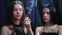 Two girls smoking from each others hands