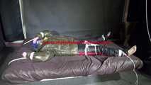 Watching Jill being tied on a bed wearing a shiny nylon rain jacket and a down jacket as well as a rain pants being double hooded and gagged with a ballgag (Video)