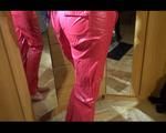 Lucy posing infront of the mirror wearing a supersexy red rainwear jumpsuit (Video)