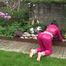 Watching Aiyana wearing supersexy pink shiny nylon rainwear while planting flowers in the garden (Video)