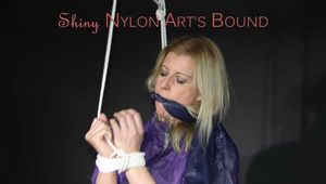 Watching Pia wearing a supersexy shiny nylon shorts and a rain jacket being tied and gagged overhead with ropes and a clothgag (Pics)