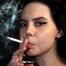 Pretty girl is smoking two cigarettes in a row and spitting