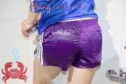 Sonja taking a shower wearing a very hot purple shiny nylon shorts and a blue rain jacket (Pics)
