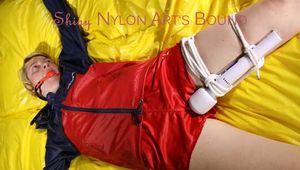 SEXY SONJA being tied and gagged on a bed stimulated with an massager wearing a hot red shiny nylon shorts and an oldschool red/blue rain jacket (Pics)