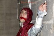 Nicole tied and gagged by Sophie in an red/silver PVC rainsuit in the cellar