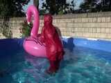 Watch Sandra watering the garden and wetting her shiny nylon oldschool Rainsuit in the Pool