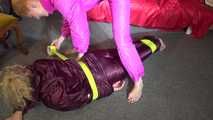 See Sophie tied and gagged by Ronja in shiny Downwear