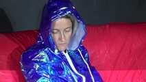 Sexy Sonja preparing her bed wearing sexy shiny nylon shorts and a long rain jacket (Video)