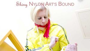 SEXY PIA being tied and gagged on a stairway with cuffs and a cloth gag wearing a sexy red shiny nylon shorts and a yellow rain jacket (Pics)