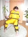 Jill tied, gagged and hooded with a tension belt on a chair wearing a supersexy yellow shiny nylon rainpants and rain jacket (Pics)