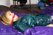 Samantha ties and gagged herself on bed wearing a shiny purple nylon shorts and a shiny green transparent rain jacket (Pics)