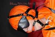 Sexy Pia being tied and gagged with belts a eye patch and a ballgag on a chair wearing a supersexy oldschool orange rainsuit (Pics)
