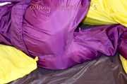 Lucy wearing a supersexy purple rain suit with hood while preparing her bed (Pics)