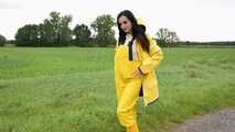 Miss Amira on the road in a Frisian mink, yellow rain dungarees and rubber boots