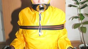 Jill tied, gagged and hooded with a tension belt on a chair wearing a supersexy yellow shiny nylon rainpants and rain jacket (Pics)