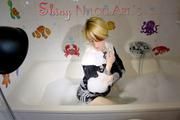 Sonja taking a bath wearing a sexy black shiny nylon shorts and a rain jacket playing with the foam and the water as well as her clothes (Pics)