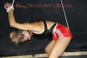 Sexy Sandra being tied and gagged overhead wearing a sexy red shiny nylon shorts and a black swimsuit (Pics)