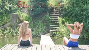 Stella and Leonie posing on a lake wearing sexy shiny nylon shorts and tops (Pics)
