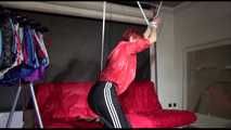 Sonja tied with ropes overhead and gagged wearing a sexy black rain pants and a special red rain jacket (Video)