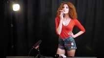 Skinny girl with wild red hair loves smoking a 120mm between the shooting